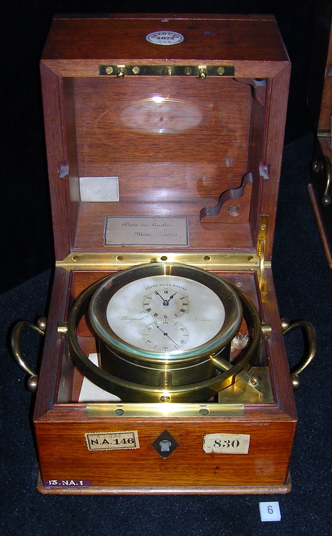 A historical Breguet marine chronometer in a wooden case with a brass suspension