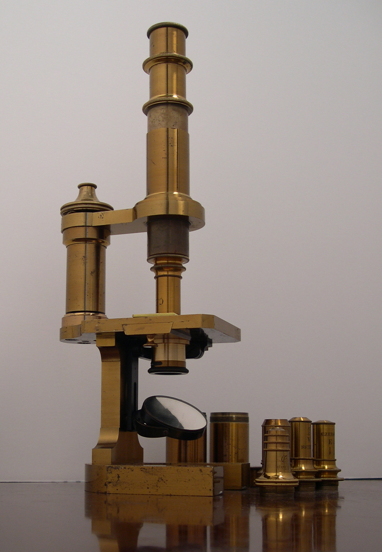 An authentic Zeiss brass microscope with accessories and a wooden case